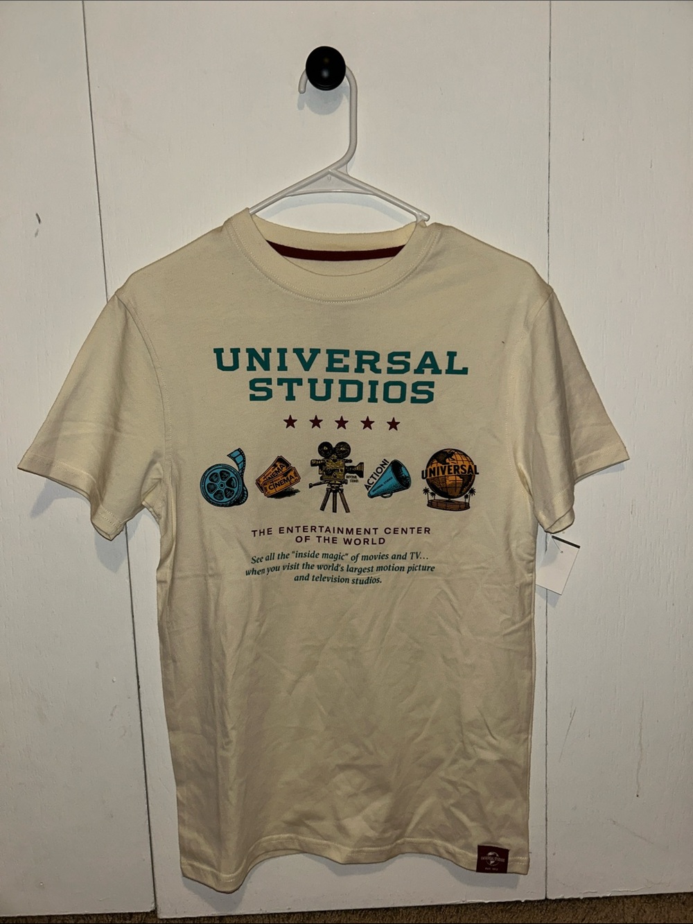 Universal Cream Tee with Teal and Brown Graphics